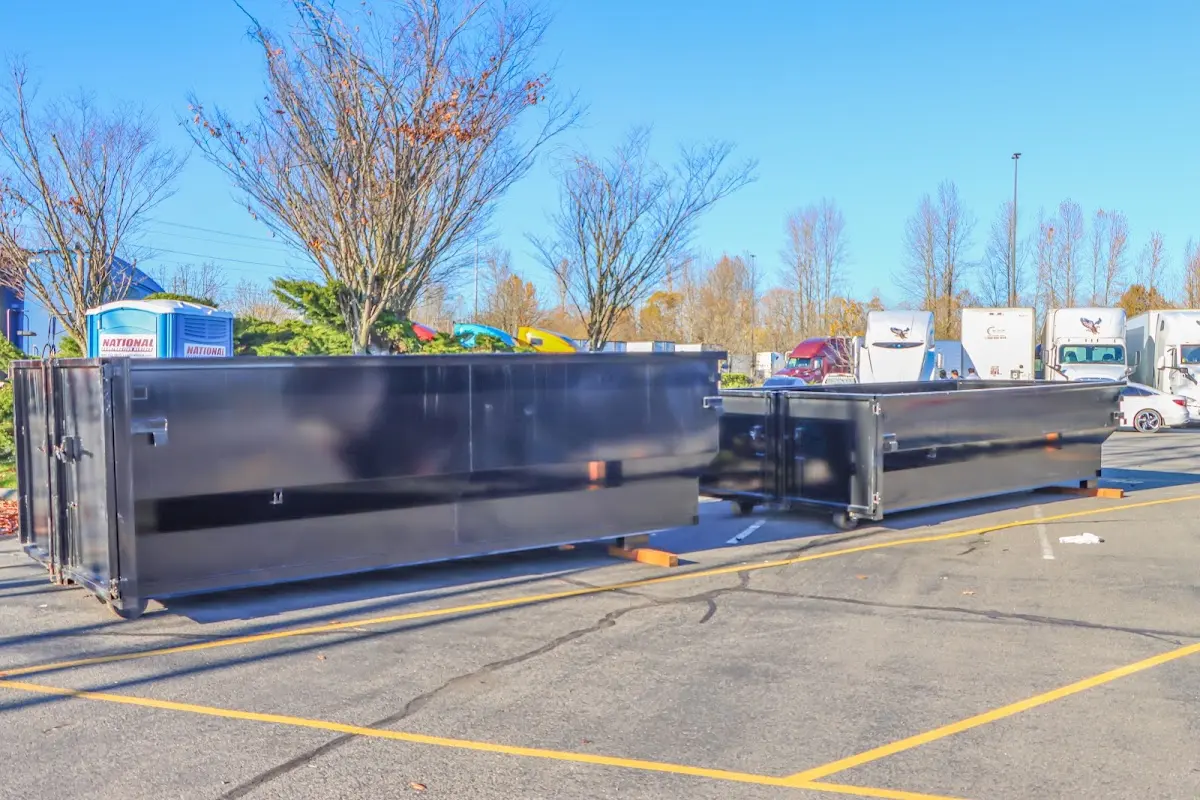 Professional dumpster rental service with roll-off container on residential driveway in Findlay